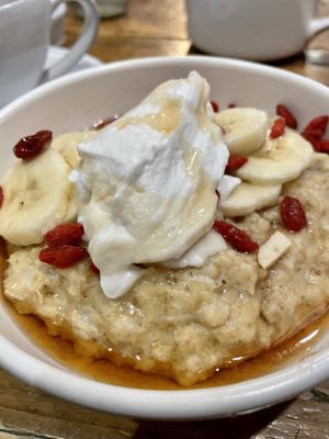 Porridge w/goji berries, bananas, and coconut yogurt   at The White Hart Hotel Restaurant in Kingston Upon Thames