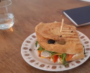 Crispy focaccia sandwich with seitan chorizo and cashew camembert at KŸNO in Brno