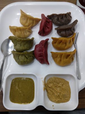 Momo set. Great leaf momo, beetroot momo, pumpkin momo and mushroom and vegetable filling. The sauces were amazing as well. at Sat Saheb in Kathmandu