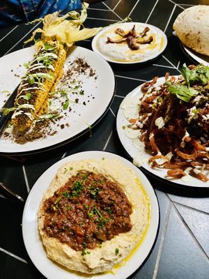 Lots of food ordered - Elote, hummus with Ragu, yogurt with dates, onion strings, pita  at Sin Muerte in Phoenix