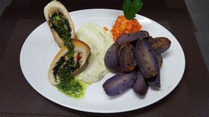 Roulade of tramezzini with filling of spinach,  tofu and paprika with violette potatoes at Vaust Braugaststatte in Berlin