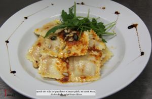 Ravioli with tofu and dried tomatoes filled,
red pistou, fresh arugula and roasted nuts
 at Vaust Braugaststatte in Berlin