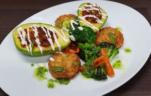Stuffed Avocado
with vegetable soya ragout (leek, tomatoes, carrots, onions, corn and red beans), 
served with roasted potatoes, broccoli and carrots, herb pesto and sesame ketch at Vaust Braugaststatte in Berlin