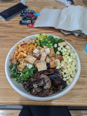 Bowl with tofu, mushrooms, corn, broccoli, spicy slaw, saffron rice, and kale at Fresh One Kitchen in Kennesaw
