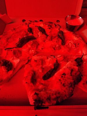 Hard to photograph in the red light, but this is the tapas pizza. at El Vato Loco in Barcelona
