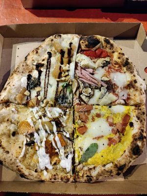 Combination of four different pizzas at El Vato Loco in Barcelona