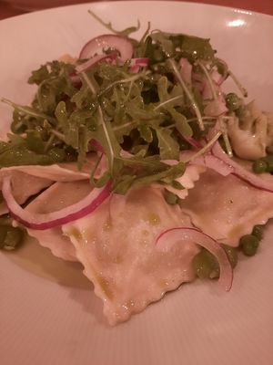 Pea & shallot ravioli with a broad beans fricassee, rocket and red onion, and a herb emulsion at The Pier in Harwich