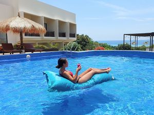 Relaxing in the pool at The Happinezz Hills Karimunjawa in 