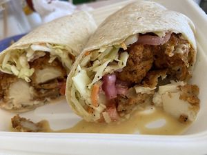 Po' Girl Wrap, made with hearts of palm, pineapple slaw, cajun remoulade sauce, pickled onions, diced tomatoes, flour wrap.  at devil's lettuce in Richmond