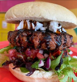 Bruschettaboutit Burger, with feta, balsamic reduction, spring mix, basil, tomatoes, and red onion (vegan) at devil's lettuce in Richmond