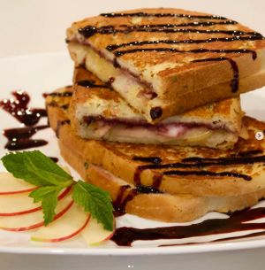 Savory Stuffed French Toast with Gouda and feta cheeses, caramelized onion-blackberry jam, pink lady apples, & blackberry balsamic reduction at devil's lettuce in Richmond