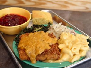 Friendsgiving Platter: chicken-fried Twin Oaks tofu, cajun gravy, mashed red potatoes, mac and cheese, braised kale, cranberry sauce. at devil's lettuce in Richmond