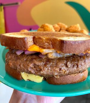 Persephone Patty Melt, with Beyond burger patty, grilled onions, spicy tomato aioli, and smoked provolone cheese, on grilled sourdough bread at devil's lettuce in Richmond