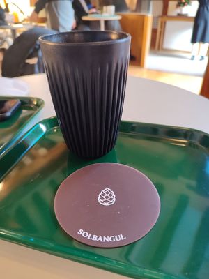 Coffee mug and cute coaster at Solbangul Bakery 솔방울베이커리 in Seoul
