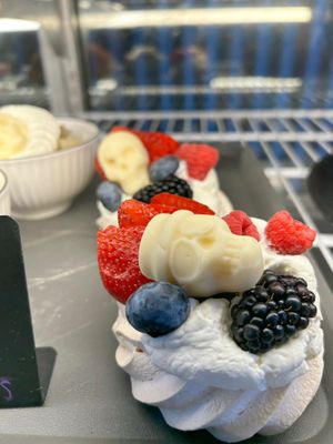 Pavola . Crispy meringue topped with whipped cream and fresh berries.  at Copenhagen European Kitchen & Bakery in Katy