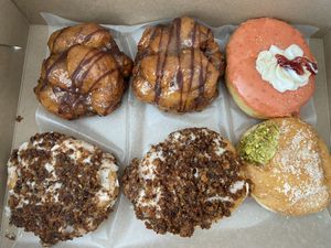 Banana chocolate chip fritters, strawberry donut, carrot cake donuts, pistachio cream donut   at bloomer's in Burlington
