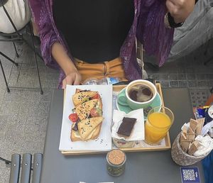Brunch menu, smoked tofu toast, granola, coffee, orange juice and desert.   at Mala Leche in Malaga