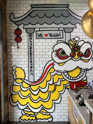 Dragon artwork on restaurant wall at Vegan District Asian Eatery in Loma Linda