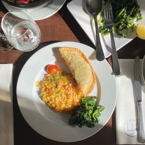 Quinoa & vegetable “pie” (you get 3 with the main course so come hungry!) with tomato rice (more in the pot!) and turnip greens (order the greens separately as a side dish).   at Belém 2 a 8 in Lisbon