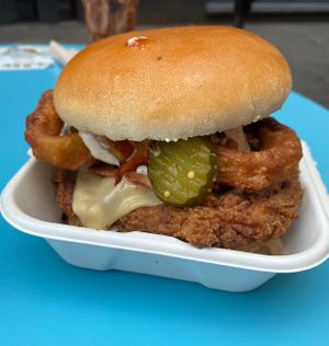 A close up of my bbq chick*n burger. It came with onion rings, pickles, cheeze, fried onions and baecon. Great brioche buns too! 😻 at V Rev Vegan Diner in Manchester