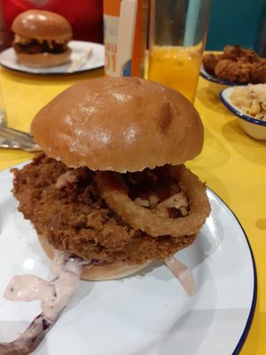 The 'Barbecute is what we aim for' chikn burger with bacon, onion rings, rainbow slaw, pickles and BBQ sauce! at V Rev Vegan Diner in Manchester
