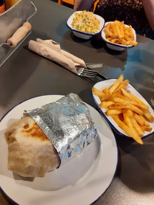 Burrito Ora (AMAZING!!!) chips, in the back ground is a mac n cheeze side at V Rev Vegan Diner in Manchester