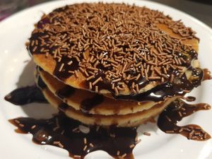 Pancakes with chocolate sauce and sprinkles at V Rev Vegan Diner in Manchester