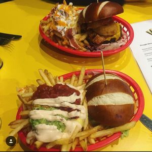 2 of the 'beef' burgers, closest one with mexican fries at V Rev Vegan Diner in Manchester