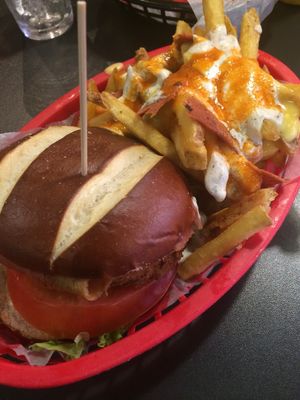 Burger with buffalo loaded fries at V Rev Vegan Diner in Manchester
