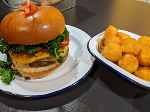 Breakfast burger and side of tater tots at V Rev Vegan Diner in Manchester