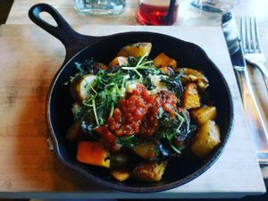 Skillet: Confit Potato, Autumn Vegetable Hash, Mustard Greens, Cashew + Squash Hollandaise, Tomato Jam at The Acorn in Vancouver
