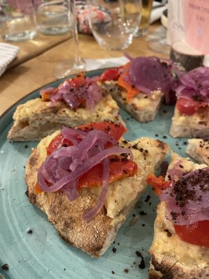 Pizza with chickpea cream, tomatoes, pickled onions and olive powder  at Il Melograno in Tavagnacco