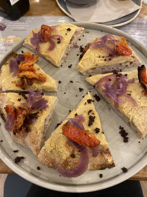 Pizza with chickpea cream, onions and sundried tomatoes   at Il Melograno in Tavagnacco