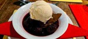 Poached pear and blackberries in a cassis sauce with vegan ice cream at The Fromeway in Radstock
