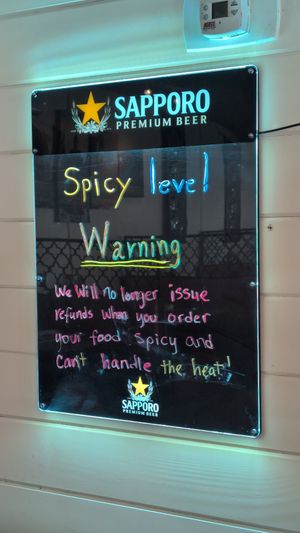 Hilarious sign on the wall. If you can't handle the heat then don't ask for it! They are spot on. at Thai and I in Bunnell