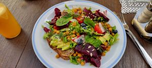 Avocado with beetroot on rye bread with salad at Klubokawiarnia Mleczarnia in Wroclaw