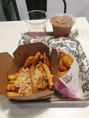 Vegan poutine, potato tots, two burgers and two drinks at Odd Burger in Calgary