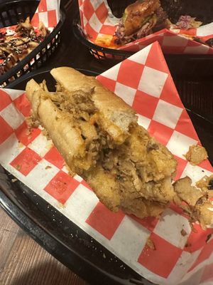 Seitan cheesesteak in front, small piece of Nashville hot left in back lol   at Algorithm in Philadelphia