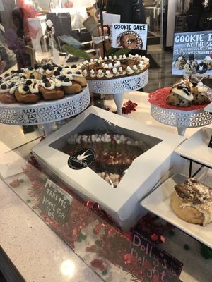 Display with cake-sized options & edible cookie dough by the scoop  at Cinnaholic in Gallatin
