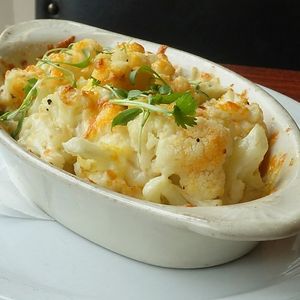 Roasted cauliflower deglazed with fresh lemon juice & chili oil. Topped with Mexican cheese blend at Choza Murrayhill in Beaverton