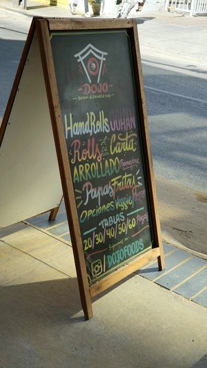 Sign outside shop advertising vegan options at Dojo Sushi & Chinese Food in Vina Del Mar