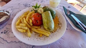 Stuffed tomato, zucchini and pepper with fries at Taverna Perissa in Santorini