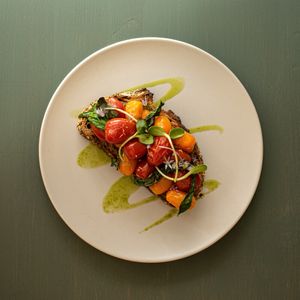 Confit tomato’s on toast with pickled shallot rings, basil oil and fresh basil  at Remedy Coffee Shop in York