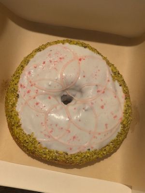 White chocolate, pistachio, cherry, red fruit at VegAmazing Doughnuts - Tirso de Molina in Madrid