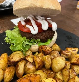 Bender burger - with Future farm burger, salad, tomatoes and vegan mayo. Roasted potatoes   at La Forgia degli Eroi in Milan