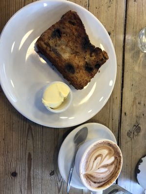 Lemon blueberry loaf with margarine and an oat milk cappuccino   at Unknown Chapter Coffee Roasters in Christchurch