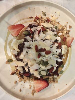 Pancakes with banana and strawberry slices, grated coconut, chocolate sauce and granola (goji berries, pepitas and oats)  at Ver De in El Nido