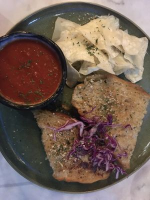 Pesto grilled cheese sandwich with taro chips and vegan mozzarella and spinach on sourdough bread. Served with marinara on the side.  at Ver De in El Nido