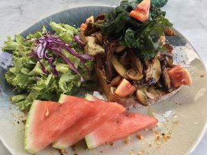Breakfast: thick cut toast with hummus and sautéed mushrooms, served with a side salad  at Ver De in El Nido