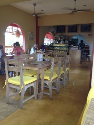 The restaurant upstairs. It's a bright, airy atmosphere with great views of the nearby buildings and gardens. Bamboo and wood furniture with yellow foam cushions. Very comfy. at Earth Cafe and Market in Ubud